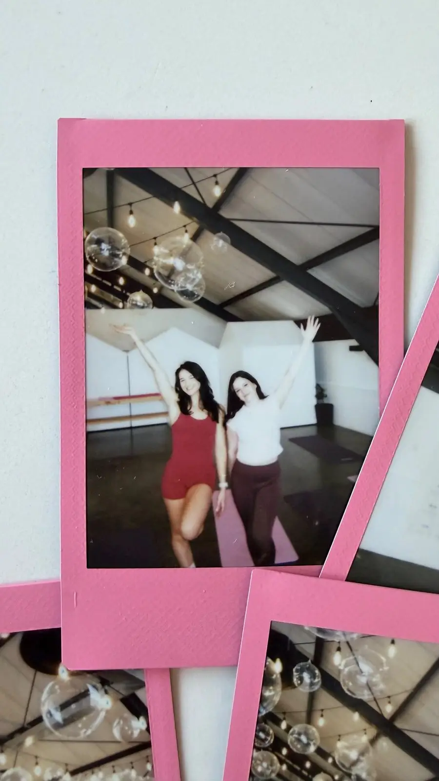 Instant photo of two women cheering, arms raised