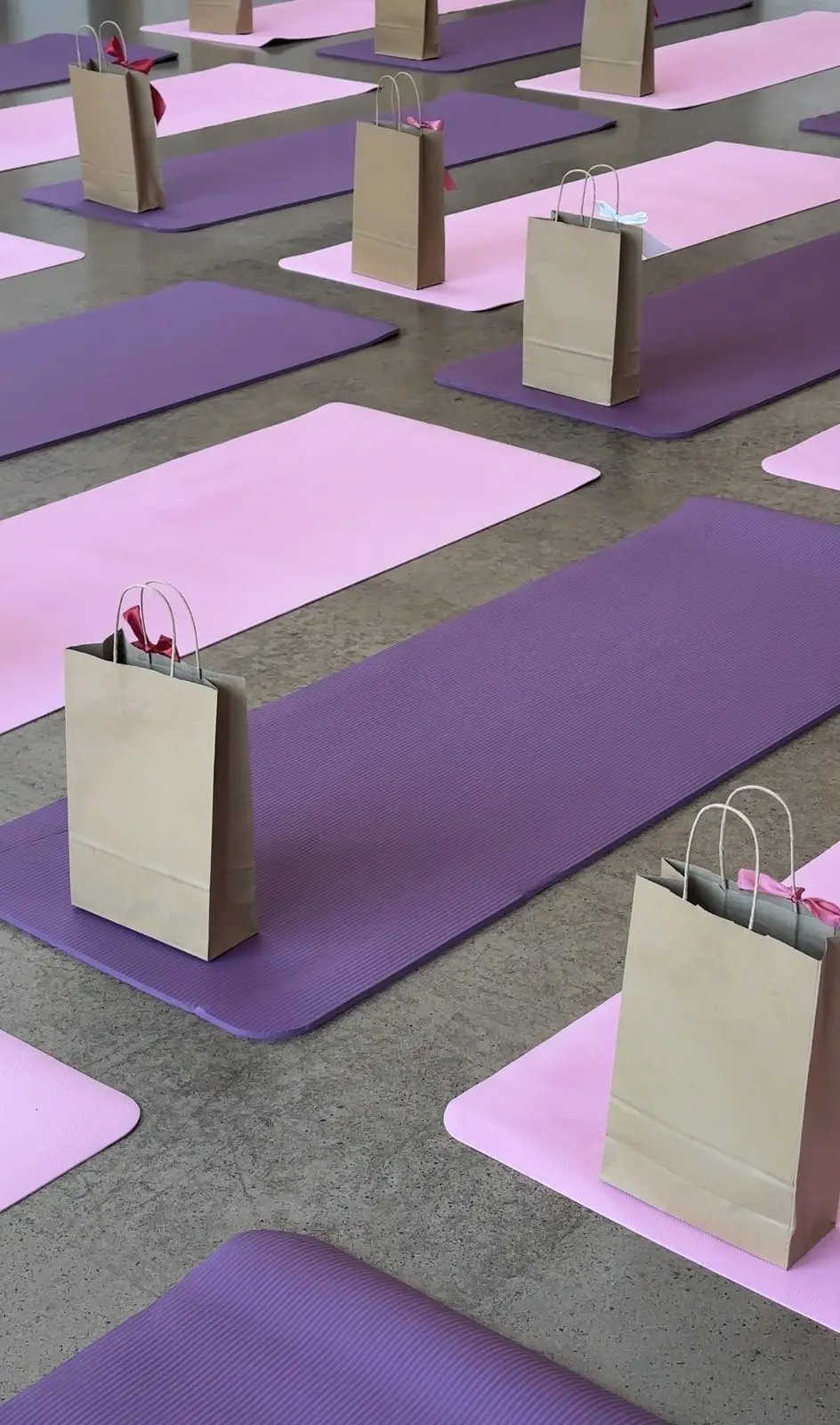 Pink and purple mats with a gift bag waiting on each