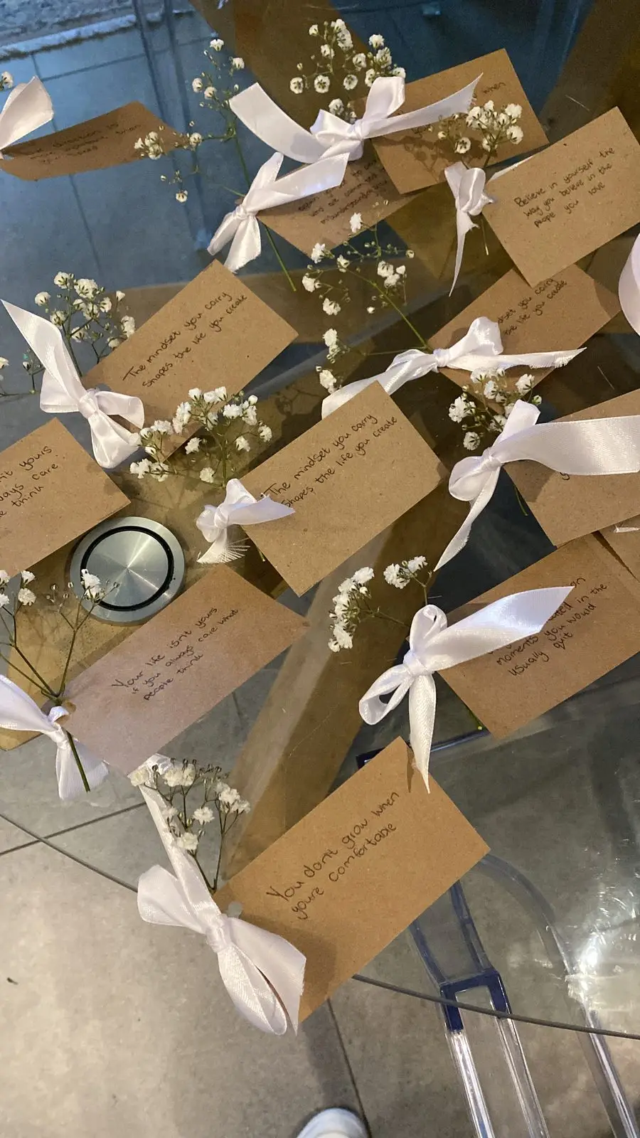 Handwritten notes tied with white ribbon and baby's breath